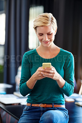 Buy stock photo Shot of an attractive woman using her cellphone at the office