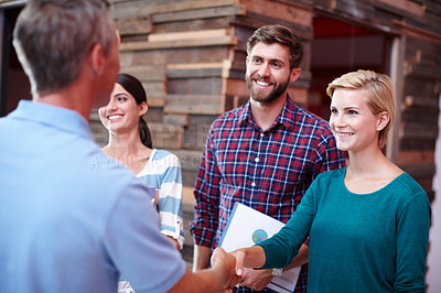 Buy stock photo Shot of coworkers shaking hands in an office