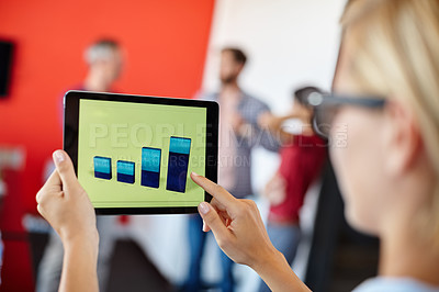 Buy stock photo Over the shoulder shot of a female designer looking at graphs on a digital tablet