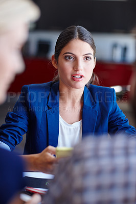 Buy stock photo Cropped shot of a young creative professional in a meeting with her coworkers