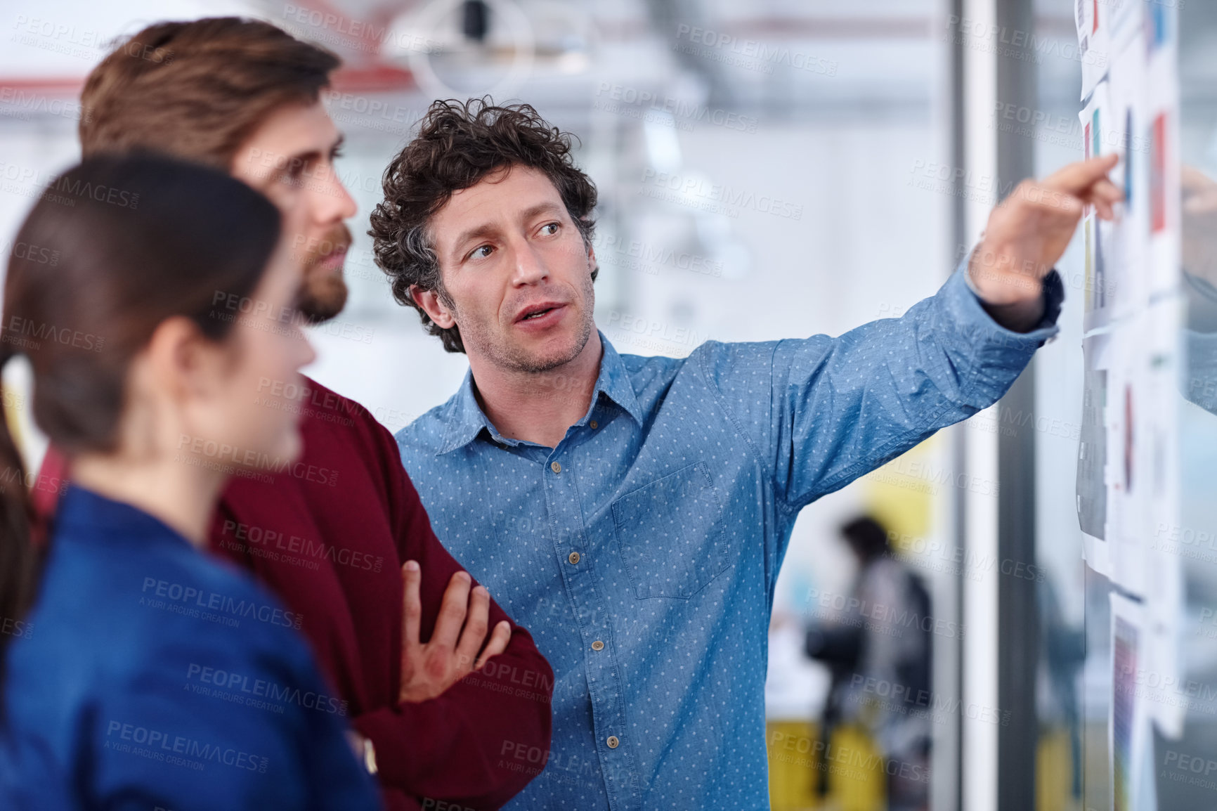 Buy stock photo Shot of a group of creative professionals working together on designs