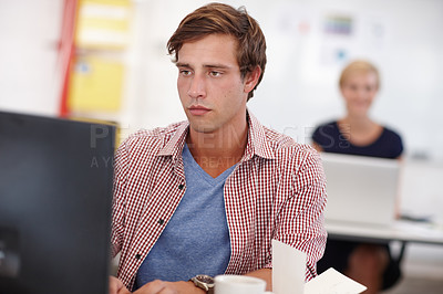 Buy stock photo Cropped shot a handsome young businessman working on his laptop