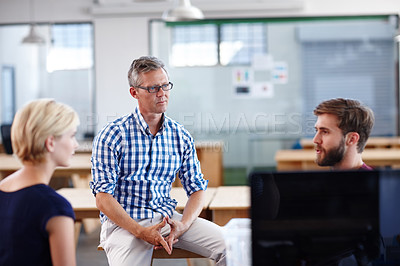Buy stock photo A group of designers having an informal office meeting