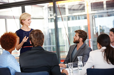 Buy stock photo Cropped shot of a female business professional sharing her ideas with her colleagues