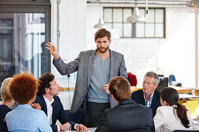 Buy stock photo Cropped shot of a businessman sharing his ideas with his colleagues