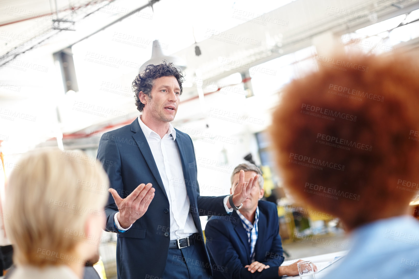 Buy stock photo Cropped shot of a businessman sharing his ideas with his colleagues