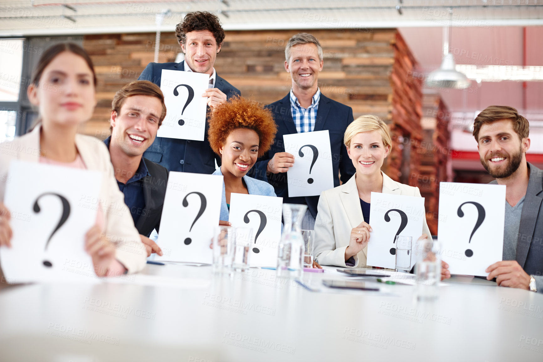 Buy stock photo Portrait of a group of businesspeople holding up cards with question marks on them