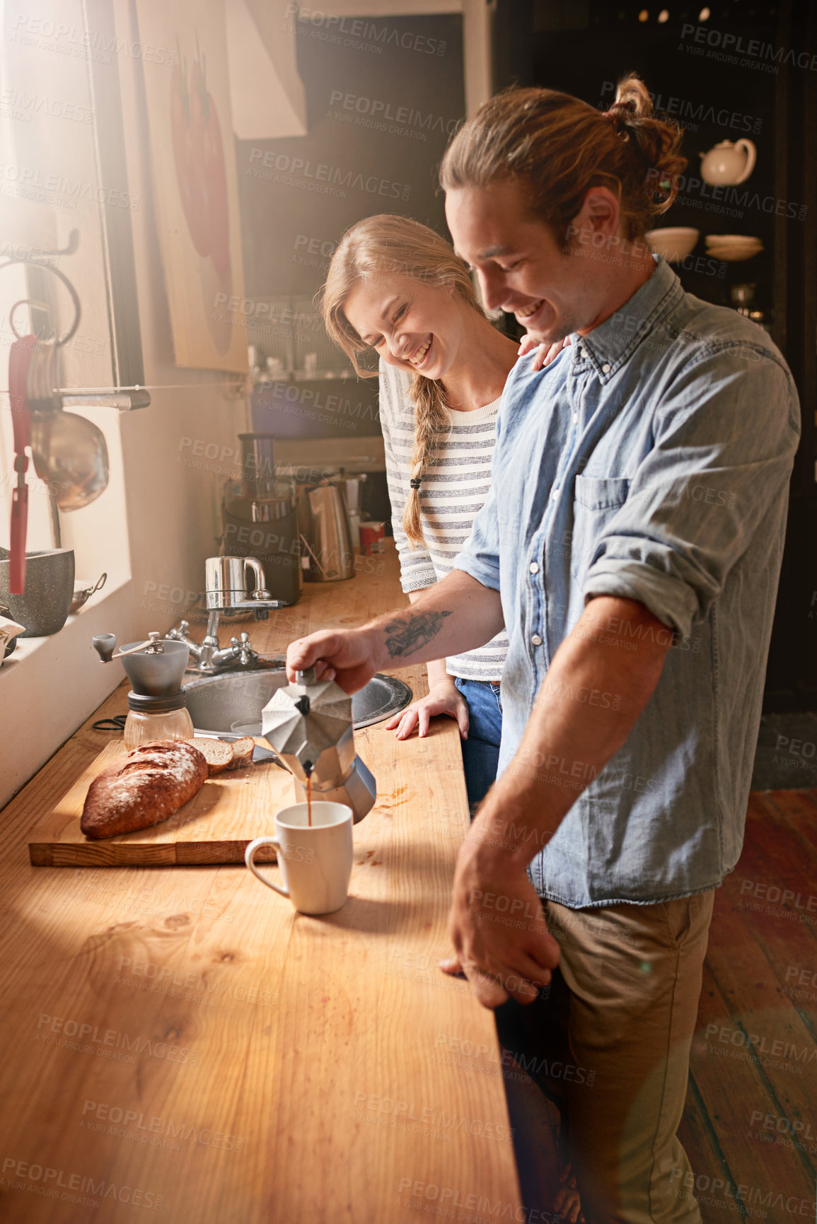 Buy stock photo Cropped shot of a young couple in the kitchen
