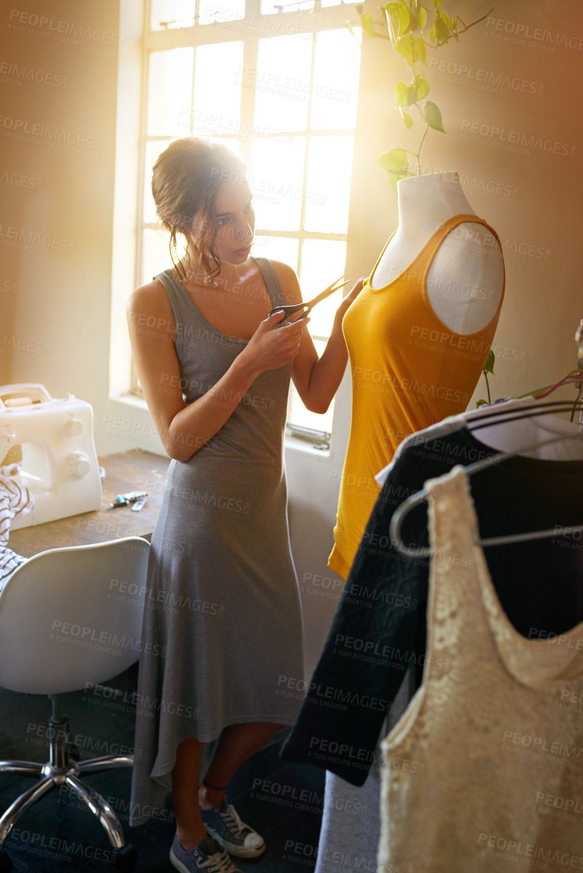 Buy stock photo A young designer making a garment in her workplace