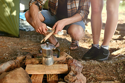 Buy stock photo Shot of campers preparing a campfire to make coffee