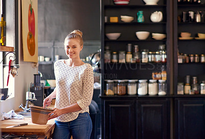 Buy stock photo Shot of a beautiful young woman preparing food in her kitchen