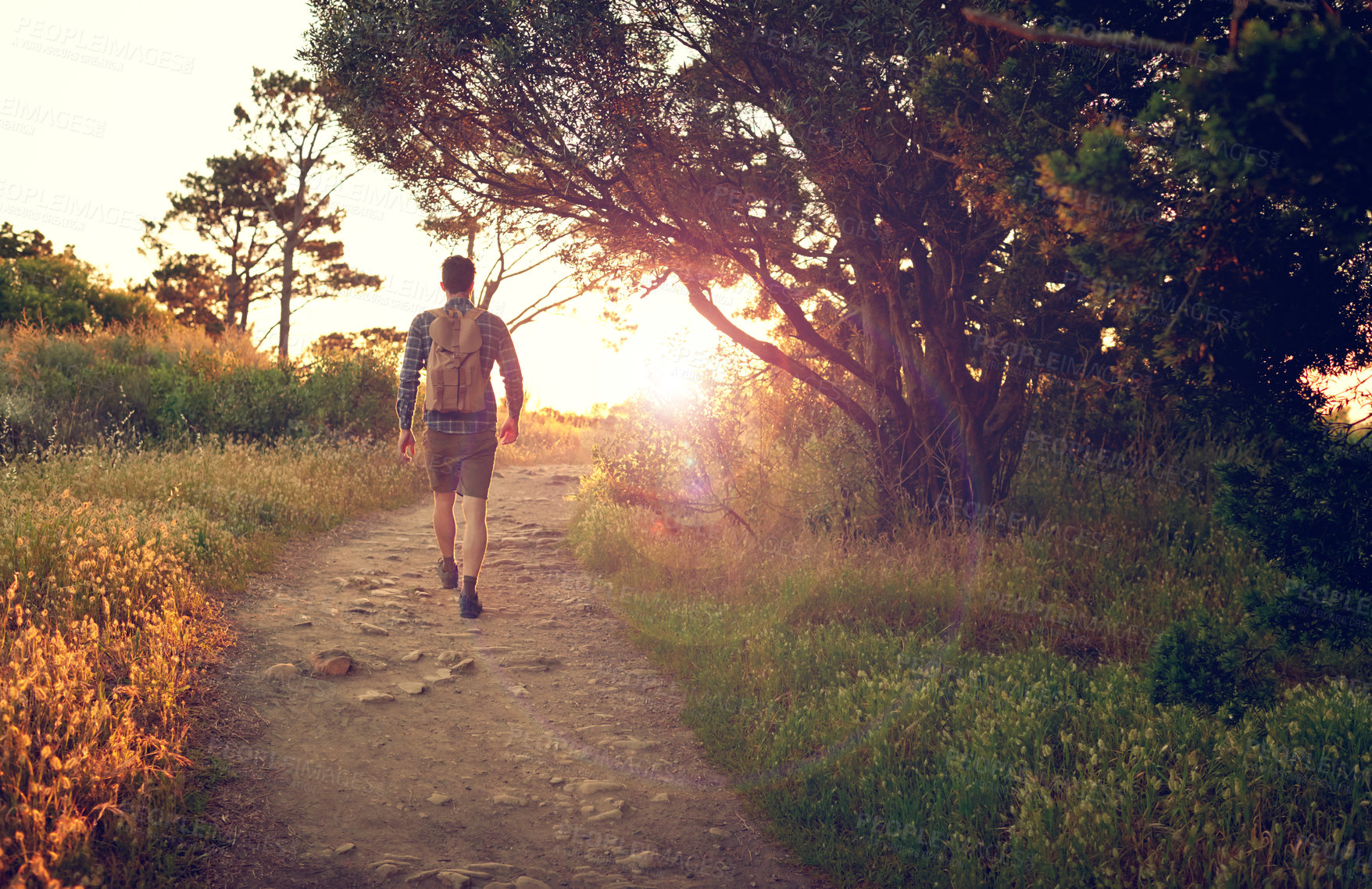 Buy stock photo Shot of a handsome young man enjoying a hike