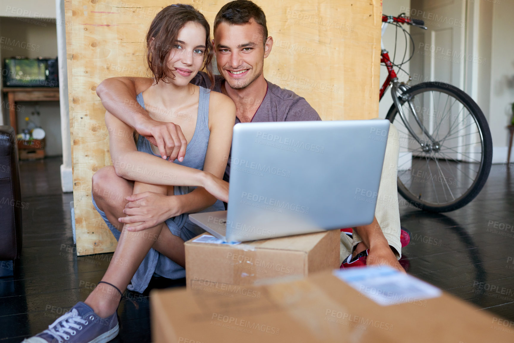 Buy stock photo Happy couple, laptop and new house with portrait on floor, care and relax with streaming, video and pride. People, man and woman by computer for love, hug and moving with real estate in Portugal