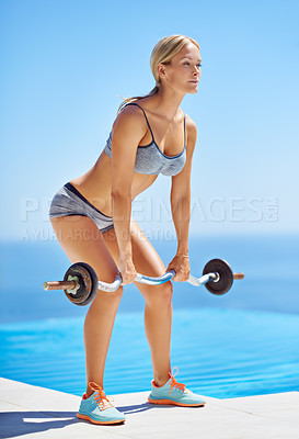 Buy stock photo Full length shot of an attractive young woman exercising with weights outside