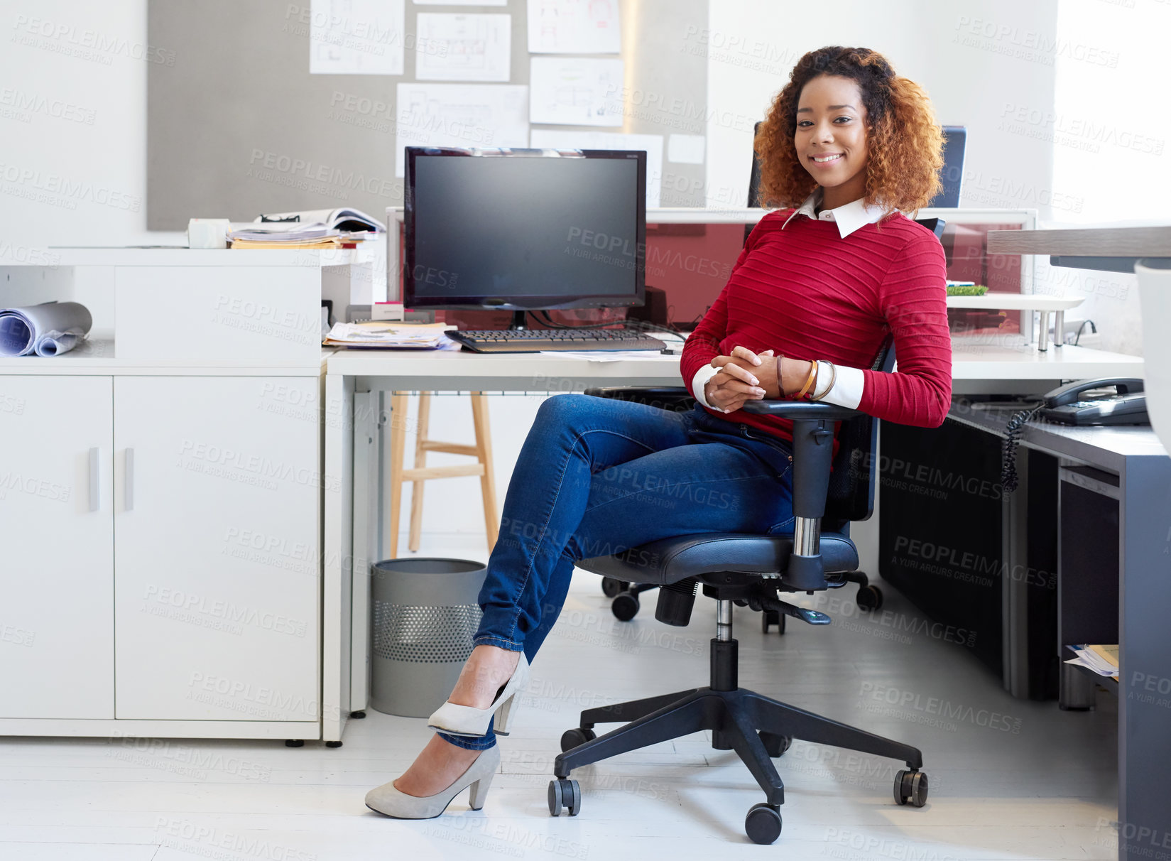 Buy stock photo Portrait of a young designer sitting at her workstation in an office