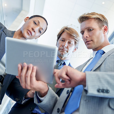 Buy stock photo Business people, tablet and cooperation for project in office, collaboration and low angle for proposal. Staff, workplace and teamwork for problem solving, support and online for review or networking
