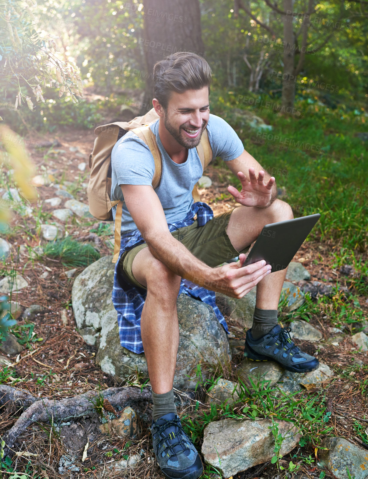 Buy stock photo Shot of a hiker using his digital tablet