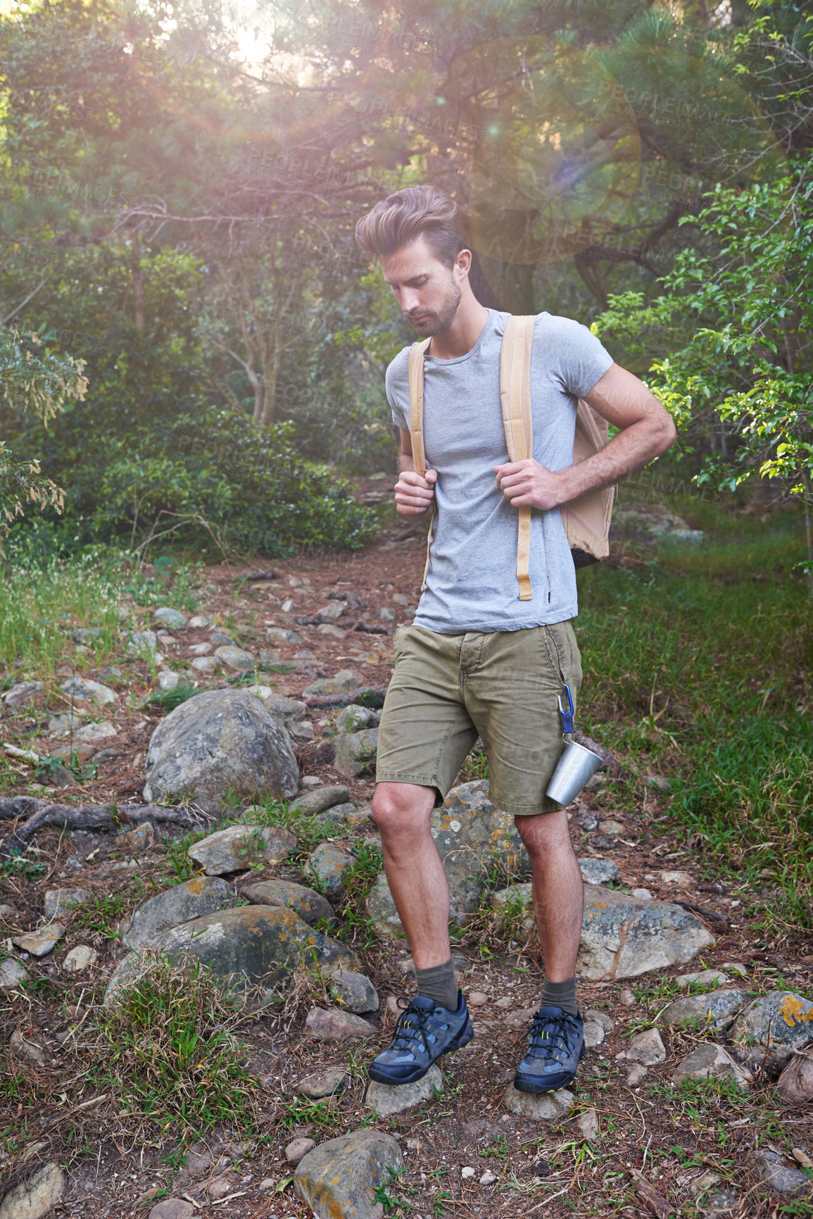 Buy stock photo Shot of a handsome man hiking in the forest