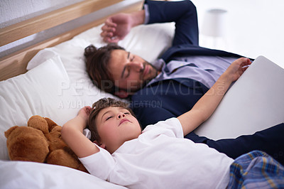 Buy stock photo Businessman, sleeping and together with child in house for comfort, relax and pyjamas to dream in bedroom. Tired, peace and dad with son on bed, cute and sweet moment for parent after work in home