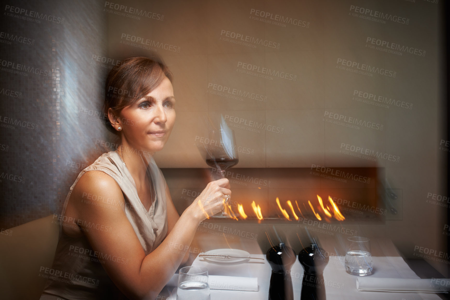 Buy stock photo Woman, motion blur and wine glass for dinner, restaurant and table for celebration. Alcohol, intoxicated or drunk for date at night, luxury and party at fine dinning place with glass at social event
