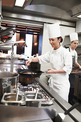 Buy stock photo Chef, woman and frying pan with sauce in kitchen, catering service and prepare food for restaurant fine dining. Professional, cooking and female saucier, cook or person with meat meal for hospitality