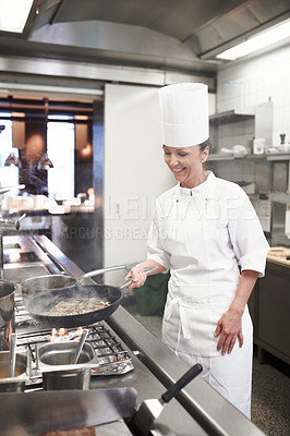 Buy stock photo Chef, woman and frying pan in restaurant kitchen, catering service and prepare food for fine dining. Professional, cooking and female cook or person saute meat, making meal and smile for hospitality.