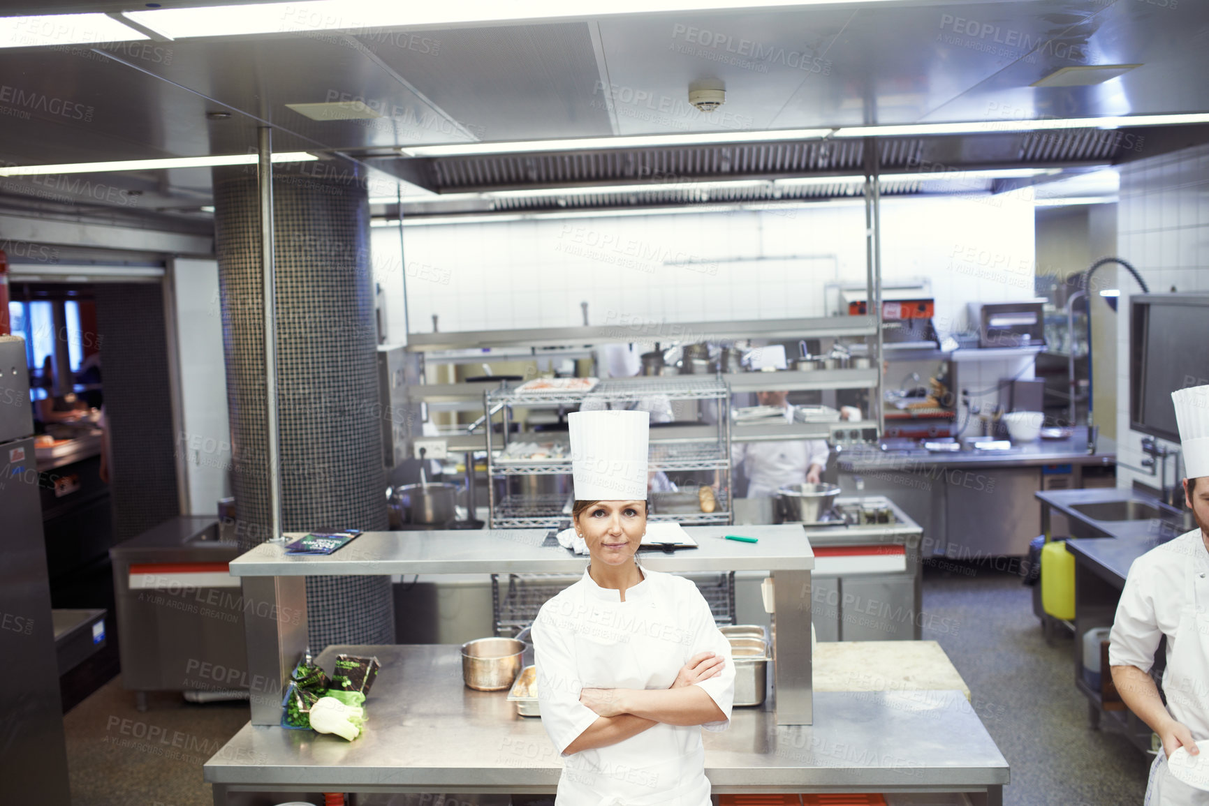 Buy stock photo Chef, woman and confident in industrial kitchen, restaurant and gourmet meal prep and serving. Crossed arms, catering service and culinary skills, nutrition and working in hospitality industry
