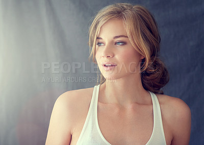 Buy stock photo Shot of a beautiful young woman looking thoughtful