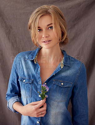 Buy stock photo Portrait of a beautiful young woman holding cut flowers