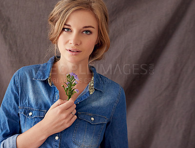 Buy stock photo Portrait of a beautiful young woman holding cut flowers