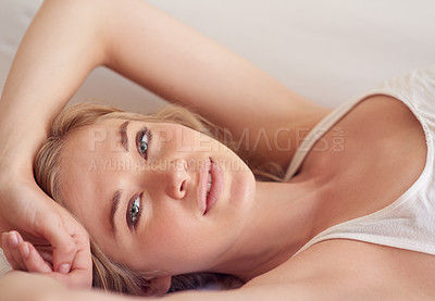 Buy stock photo Portrait of a beautiful young woman lying on her bed