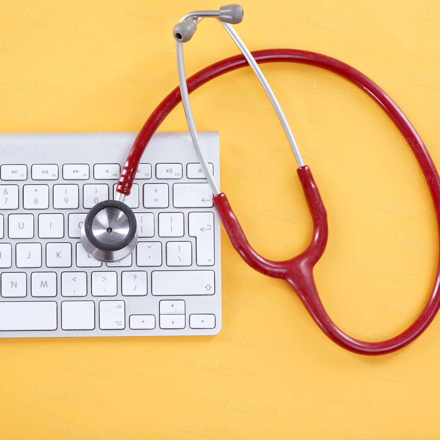 Buy stock photo Above, keyboard and stethoscope in studio for diagnostic, IT support and computer virus prevention. PC keypad, medical tool and tech on yellow background for cybersecurity, service or problem solving