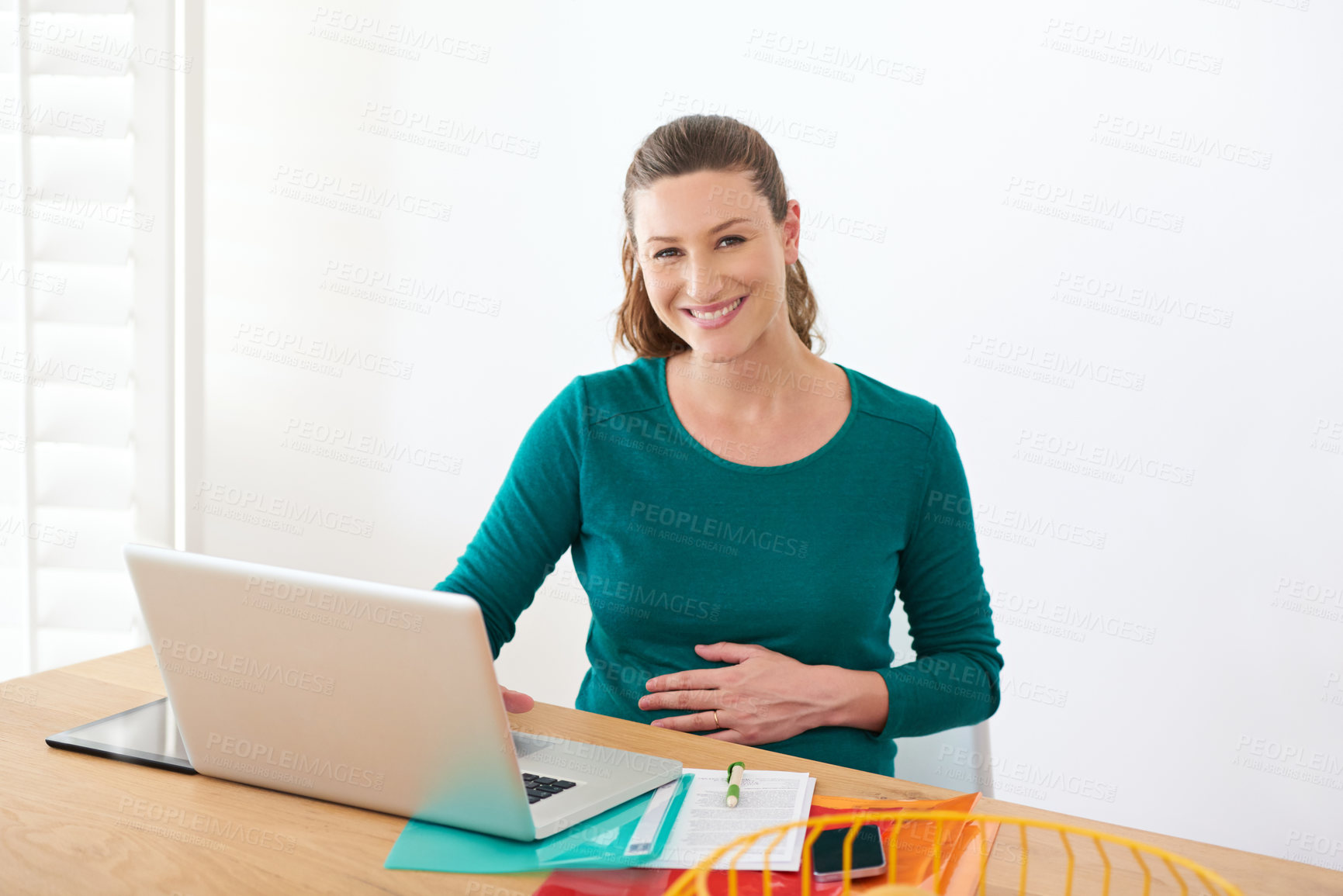 Buy stock photo Portrait of a pregnant woman sitting with her laptop at home