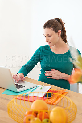Buy stock photo Shot of a pregnant woman using her laptop at home