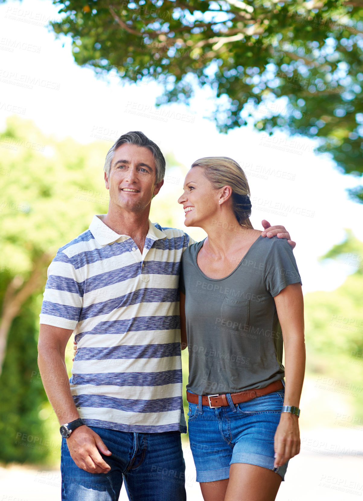 Buy stock photo Cropped shot of an affectionate mature couple enjoying a day in the park