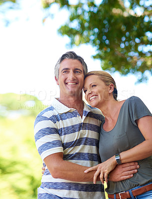 Buy stock photo Cropped shot of an affectionate mature couple enjoying a day in the park
