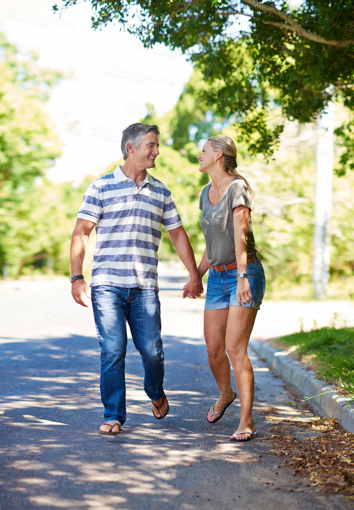 Buy stock photo Full length shot of an affectionate mature couple enjoying a day in the park