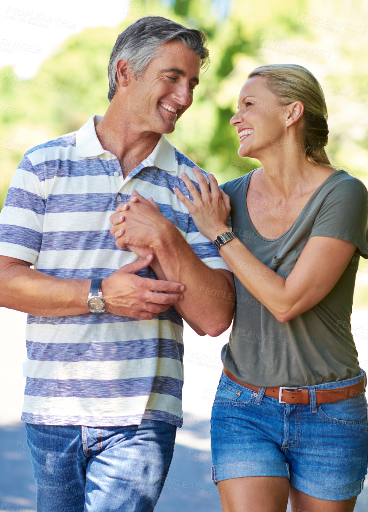 Buy stock photo Cropped shot of an affectionate mature couple enjoying a day in the park