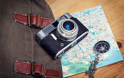 Buy stock photo Holiday, map and compass with camera on table for itinerary schedule, adventure explore and direction. Vintage, photography and travel with vacation planning for tourism, navigation and discovery