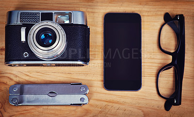 Buy stock photo Above, smartphone and camera on table for photography, hobby and equipment with glasses. Technology, multi tool and retro gear for creative, production and wooden table for picture or film items