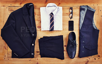 Buy stock photo High angle shot of a stylish business outfit with a smartphone laid out on a wooden table