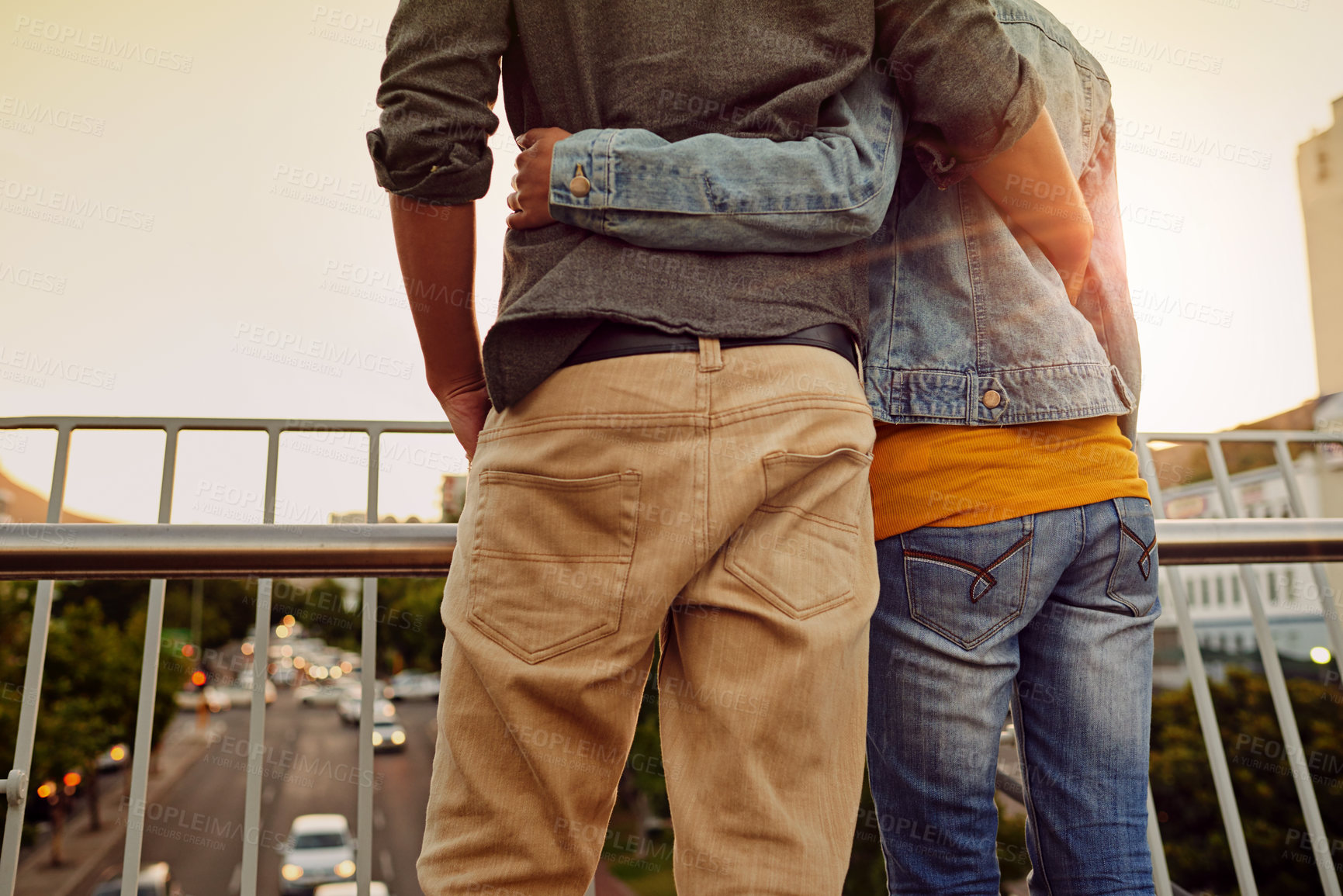 Buy stock photo Rearview shot of a couple standing together on a city bridge and looking at the view