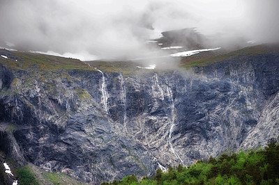 Buy stock photo Morning, waterfall and mountains with stream in winter for travel, climbing and hiking. Landscape, nature and view of natural environment, clouds and Norway countryside for calm adventure on rocks