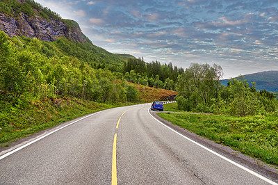 Buy stock photo Outdoor, road and car in forest by mountains, fjord and trees for transport system in summer. Landscape, clouds and traffic with highway, infrastructure and travel in environment by street in Norway