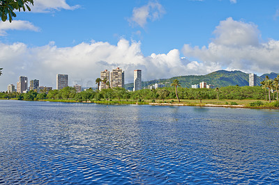 Buy stock photo Water, river and buildings in city with travel for summer vacation, nature and blue sky with clouds. Natural environment, lake and urban town with sustainability, park and island holiday in Hawaii