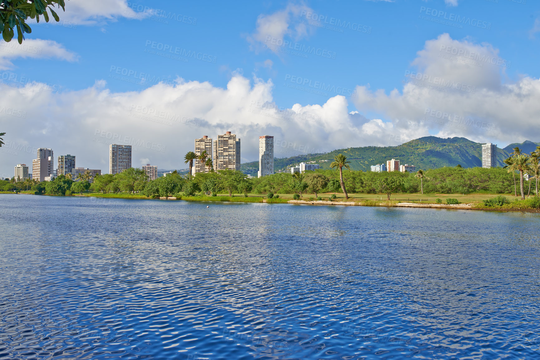 Buy stock photo Water, river and buildings in city with travel for summer vacation, nature and blue sky with clouds. Natural environment, lake and urban town with sustainability, park and island holiday in Hawaii