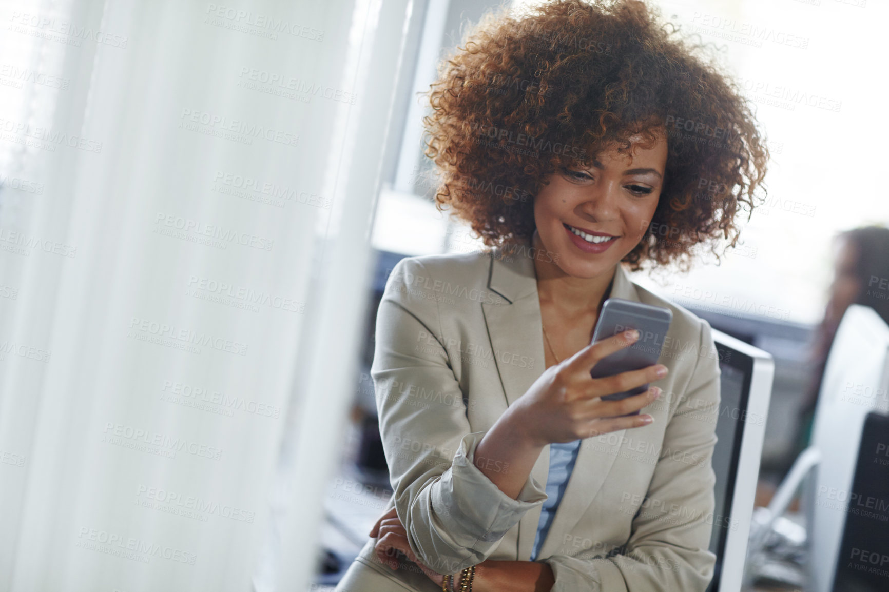 Buy stock photo Cropped shot of a beautiful young businesswoman using her phone in the office