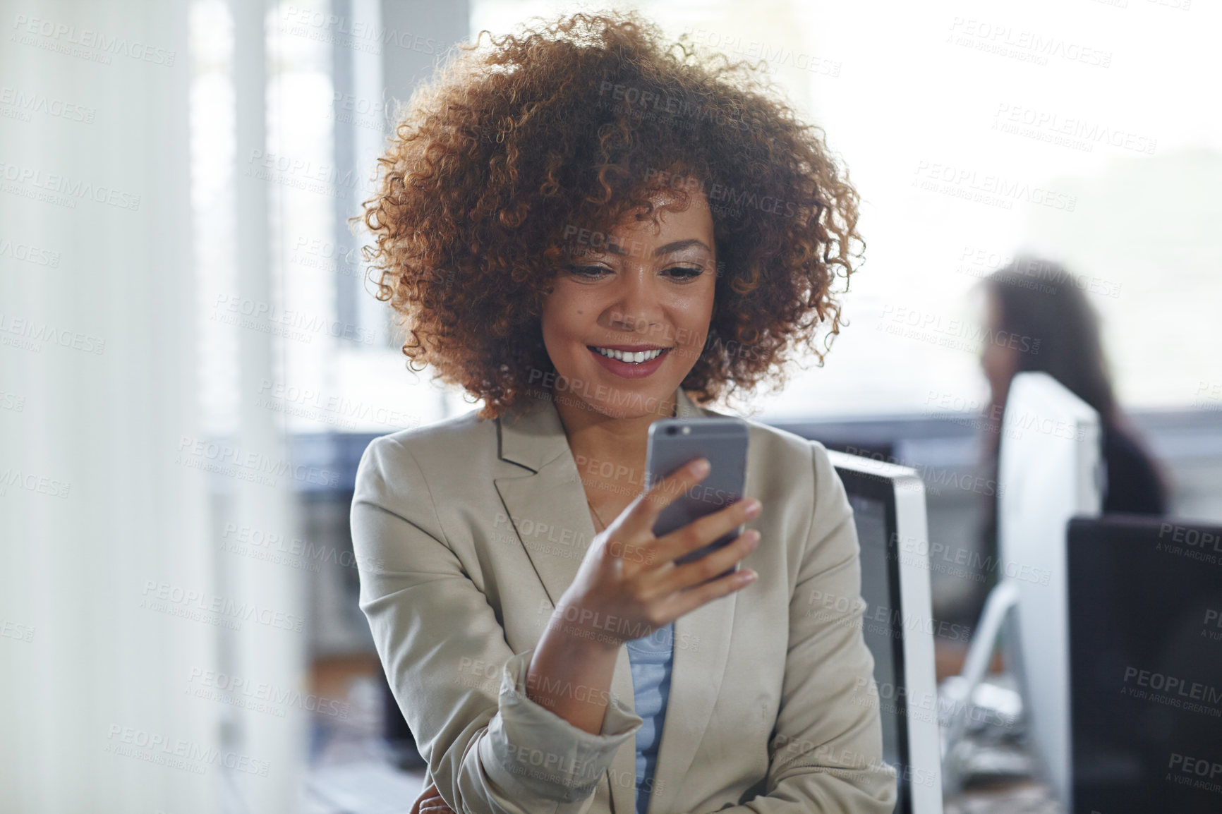 Buy stock photo Cropped shot of a beautiful young businesswoman using her phone in the office