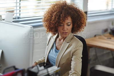 Buy stock photo Cropped shot of a beautiful young businesswoman sitting in her office