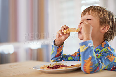 Buy stock photo A cute little boy eating breakfast